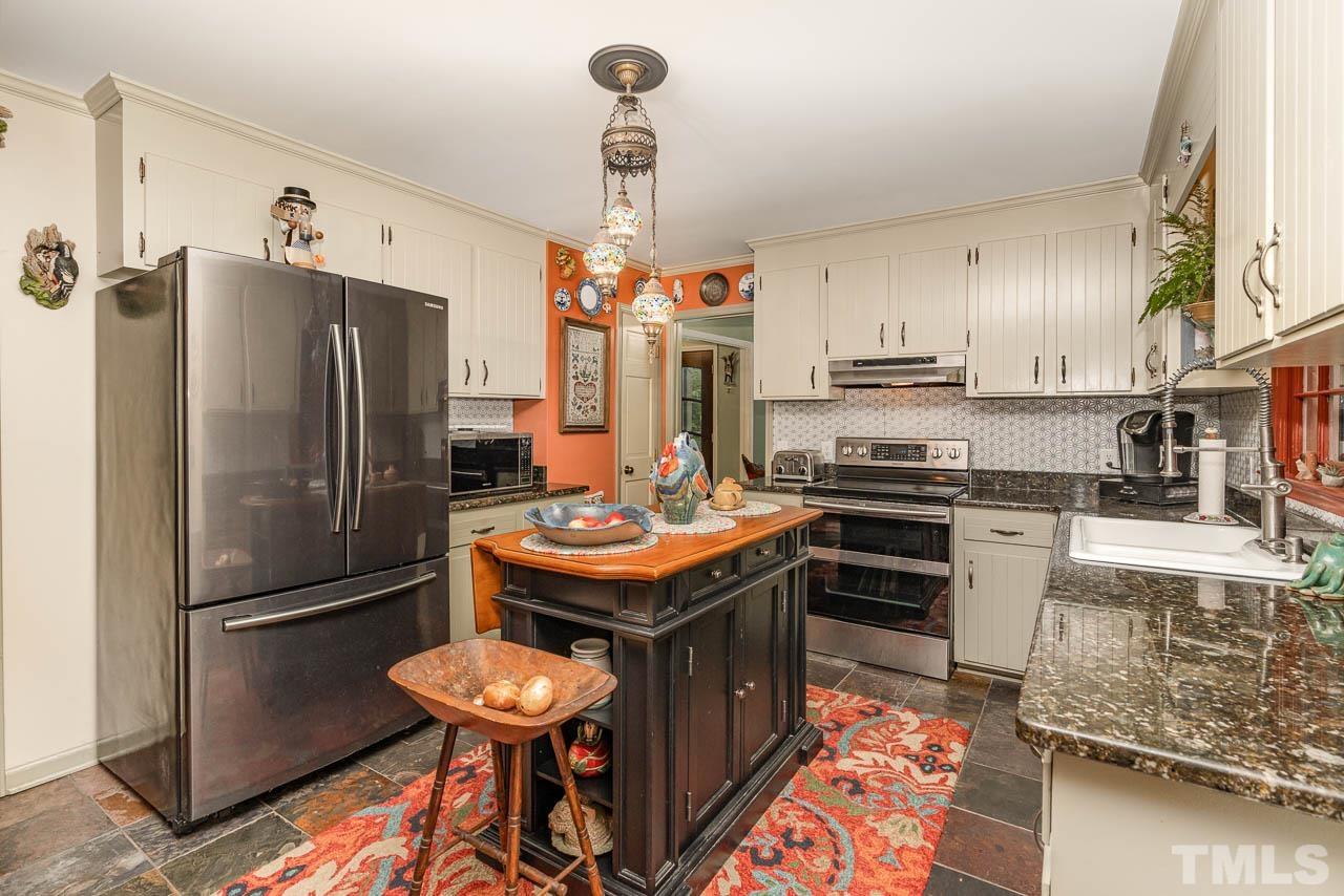 2025 Valley Ridge Court Raleigh, NC 27603 - Photo 20 of 32 a kitchen with stainless steel appliances granite countertop a refrigerator a stove a sink and a refrigerator