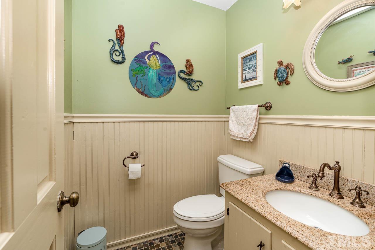 2025 Valley Ridge Court Raleigh, NC 27603 - Photo 25 of 32 a bathroom with a granite countertop toilet sink and mirror