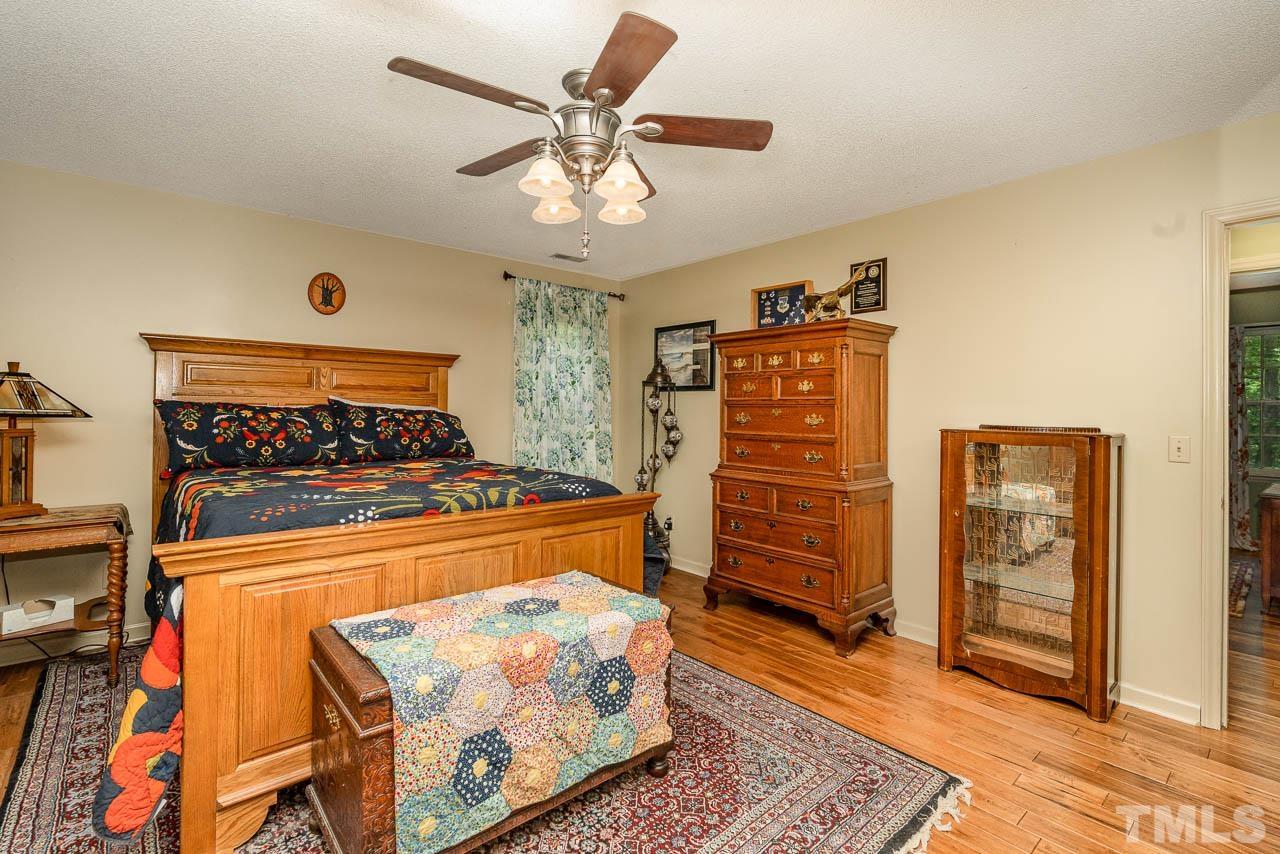 2025 Valley Ridge Court Raleigh, NC 27603 - Photo 28 of 32 a bedroom with a bed and cabinets
