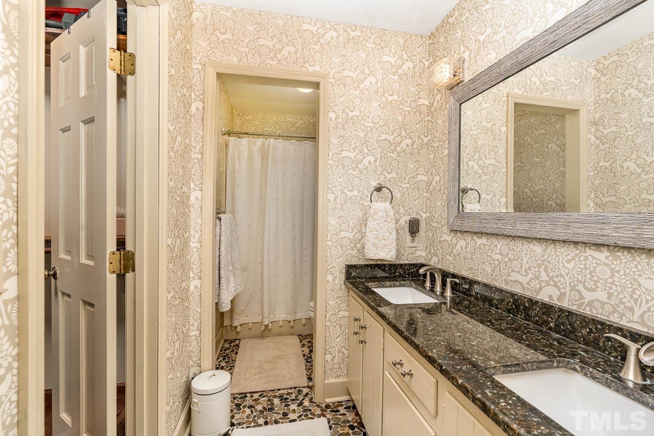2025 Valley Ridge Court Raleigh, NC 27603 - Photo 29 of 32 a bathroom with a granite countertop sink and a mirror