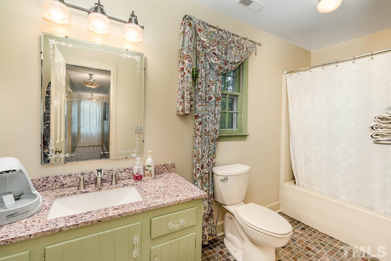 2025 Valley Ridge Court Raleigh, NC 27603 - Photo 32 of 32 a bathroom with a granite countertop sink toilet and shower