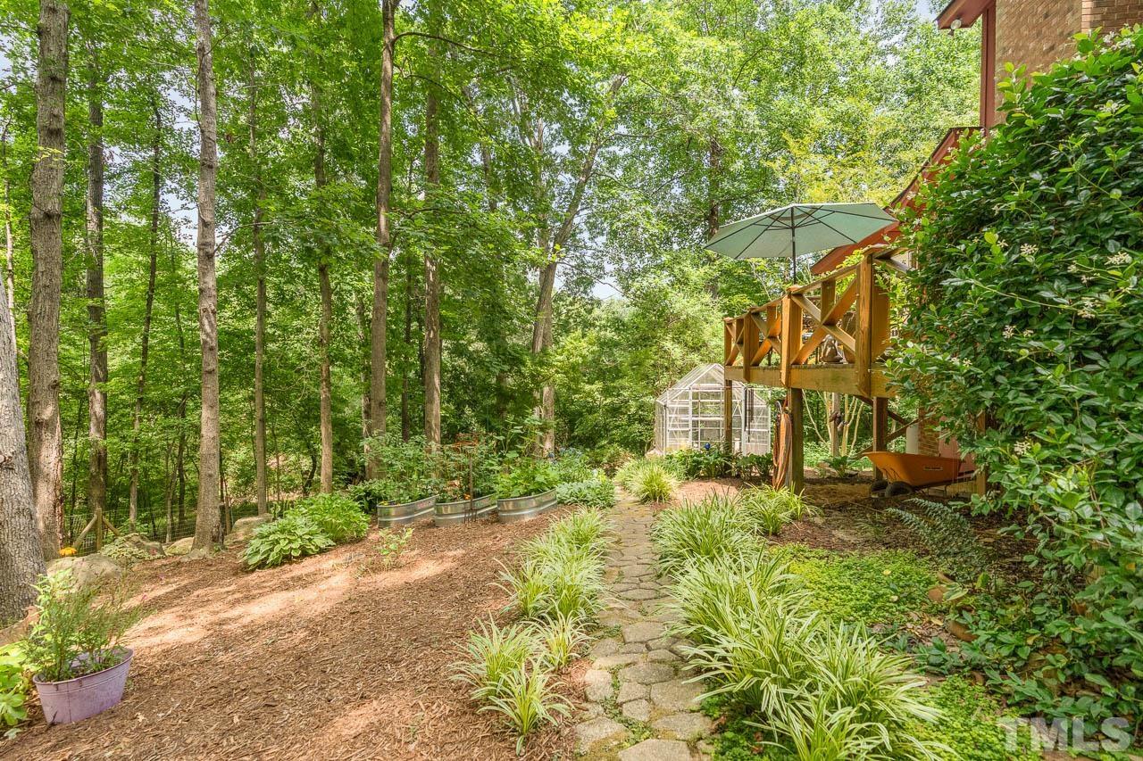 2025 Valley Ridge Court Raleigh, NC 27603 - Photo 8 of 32 a yellow building with trees in front of it
