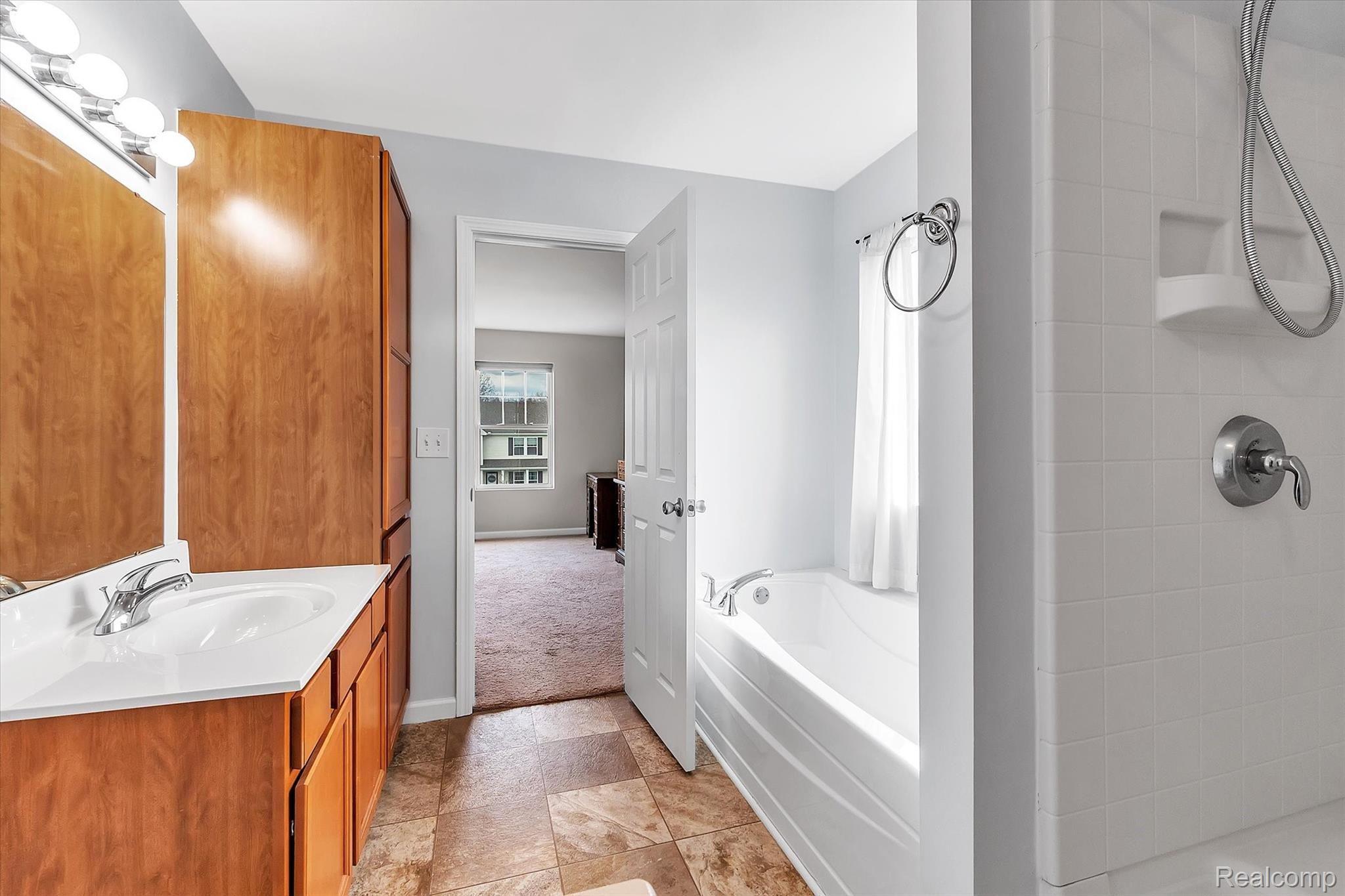 749 Dewars Street Howell, MI 48843 - Photo 23 of 39 View of en-suite full bath with walk-in shower and tub