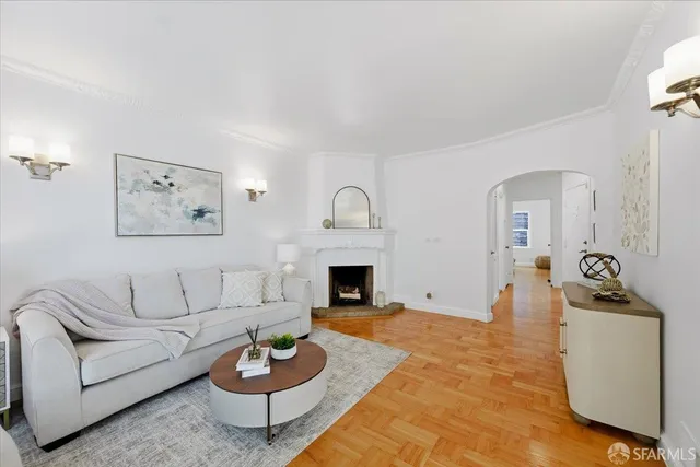 a living room with kitchen island furniture and a chandelier
