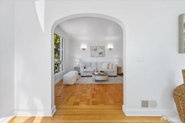 a kitchen with a table stainless steel appliances and living room