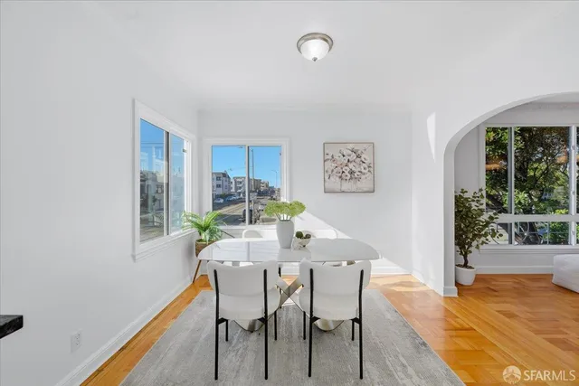 a kitchen with granite countertop a stove a sink and a refrigerator