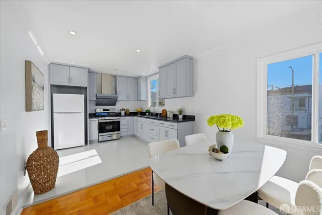 a bedroom with a bed and a potted plant on the dresser
