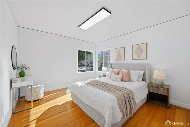 a bedroom with bed and a night stand