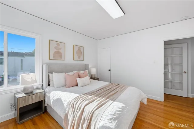 a bathroom with a granite countertop toilet a sink and a mirror