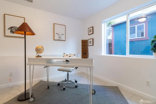 a bathroom with a sink mirror and toilet