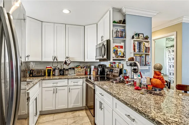 a kitchen with stainless steel appliances granite countertop a sink and cabinets