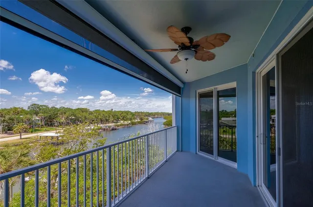 an empty room with windows and ceiling fan