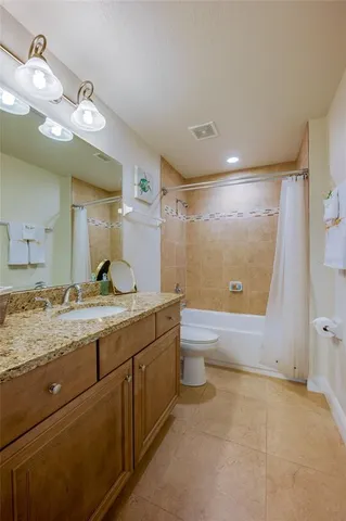 an aerial view of a house with a yard patio and lake view
