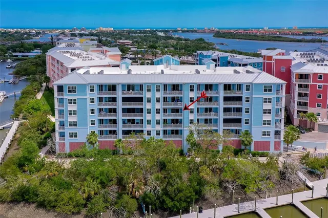 a kitchen with stainless steel appliances granite countertop a stove a refrigerator a kitchen island a table and chairs