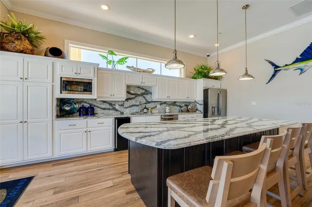 a view of a patio with table and chairs potted plants