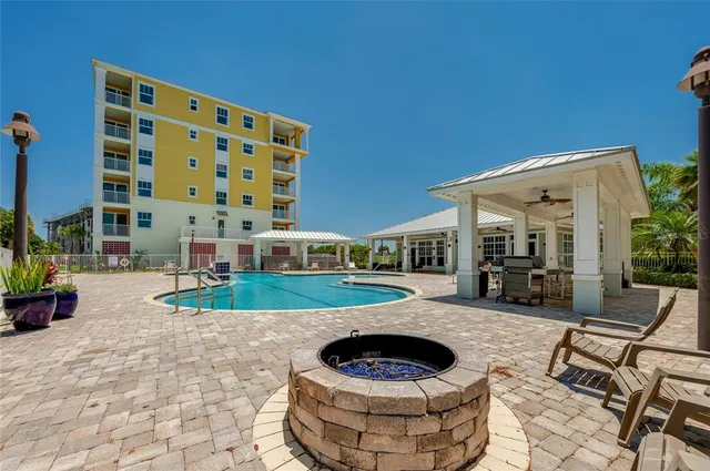 a view of a park with cars parked in front of a house