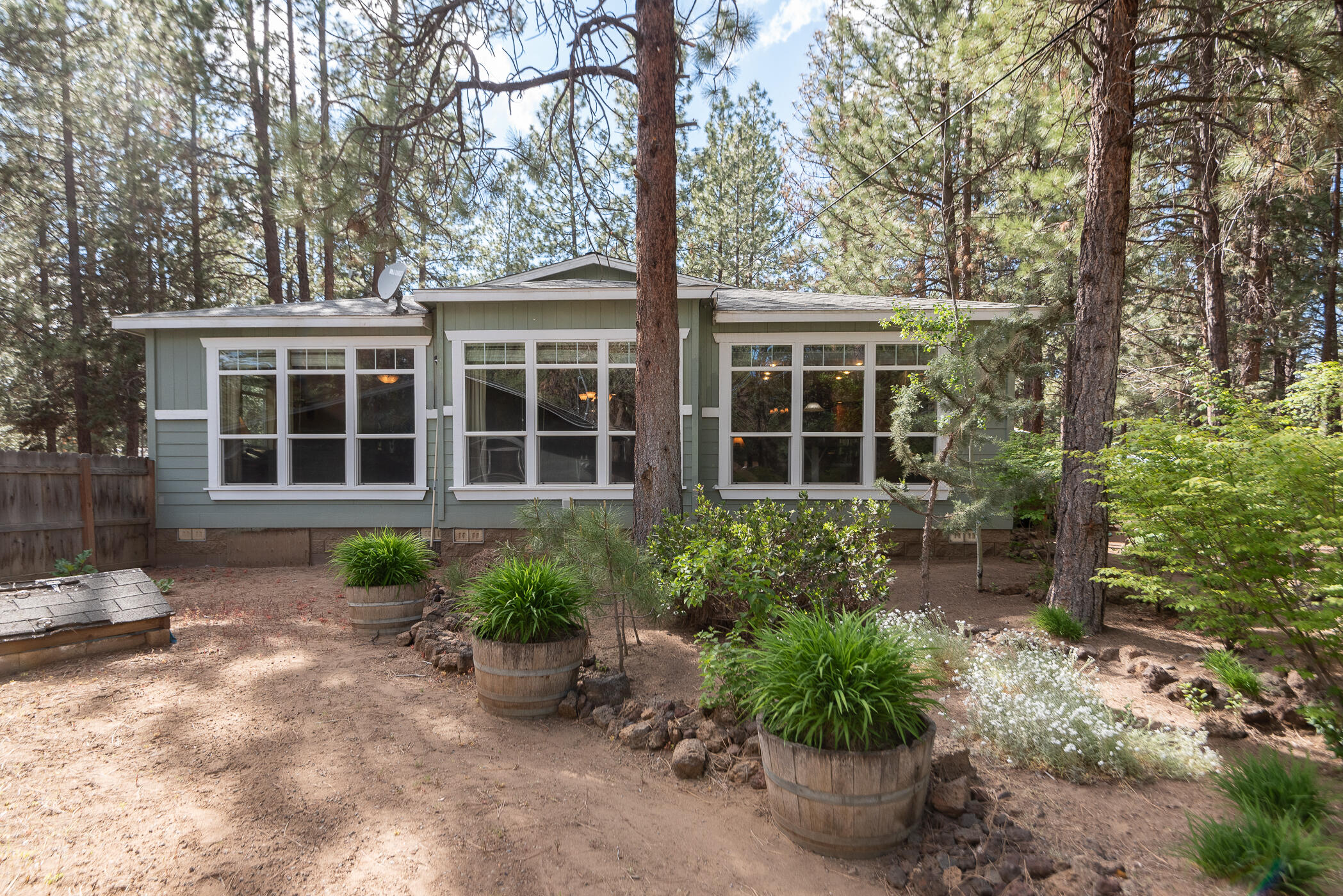 60055 Hopi Road Bend, OR 97702 - Photo 5 of 37 a front view of a house with garden