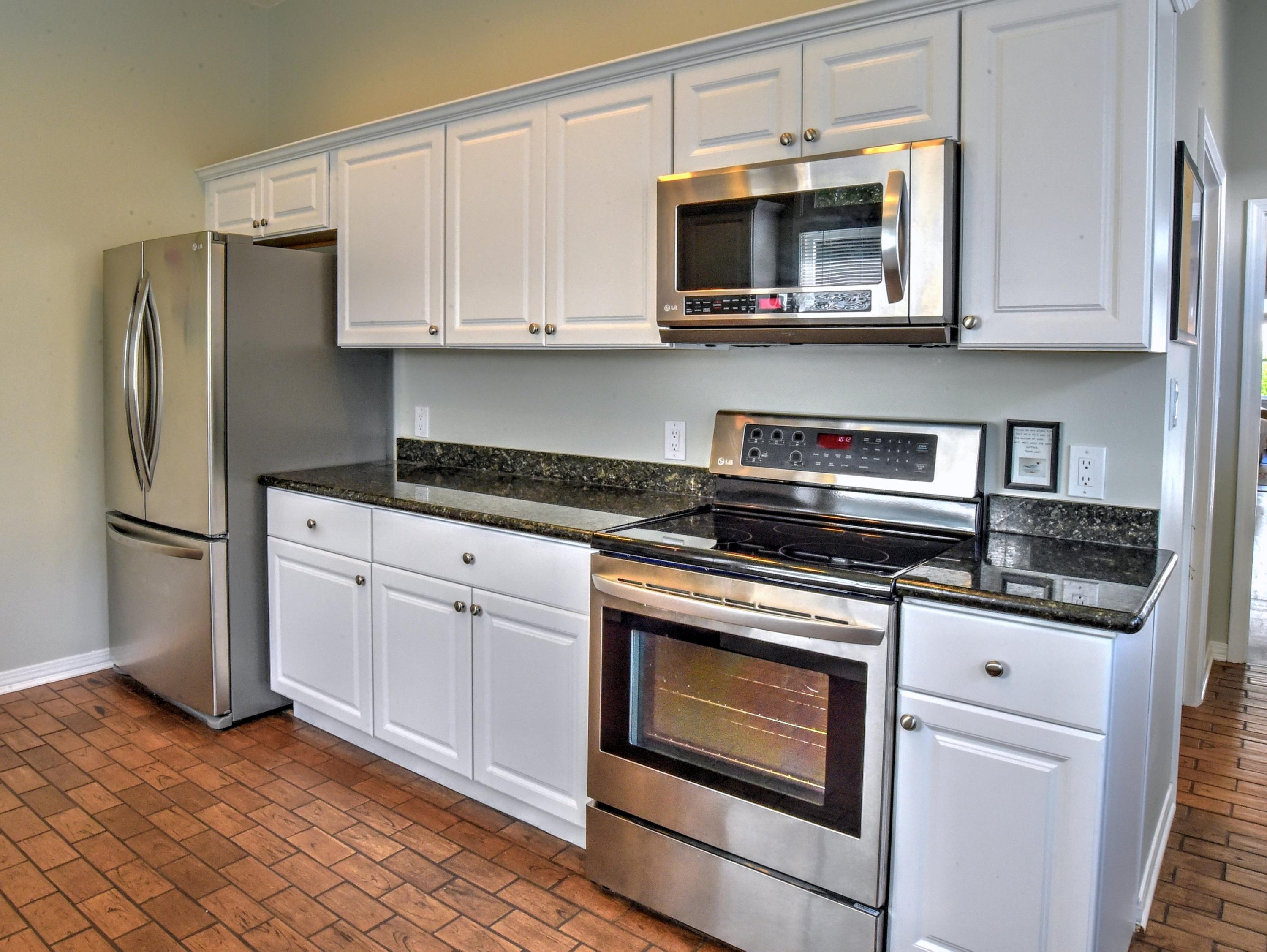 16 Bullard Road Santa Rosa Beach, FL 32459 - Photo 22 of 55 a kitchen with stainless steel appliances granite countertop a stove microwave and refrigerator