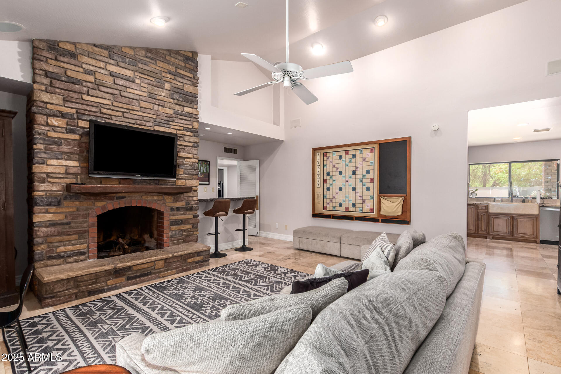 5803 North 45th Street Phoenix, AZ 85018 - Photo 20 of 72 a living room with furniture a fireplace and a flat screen tv
