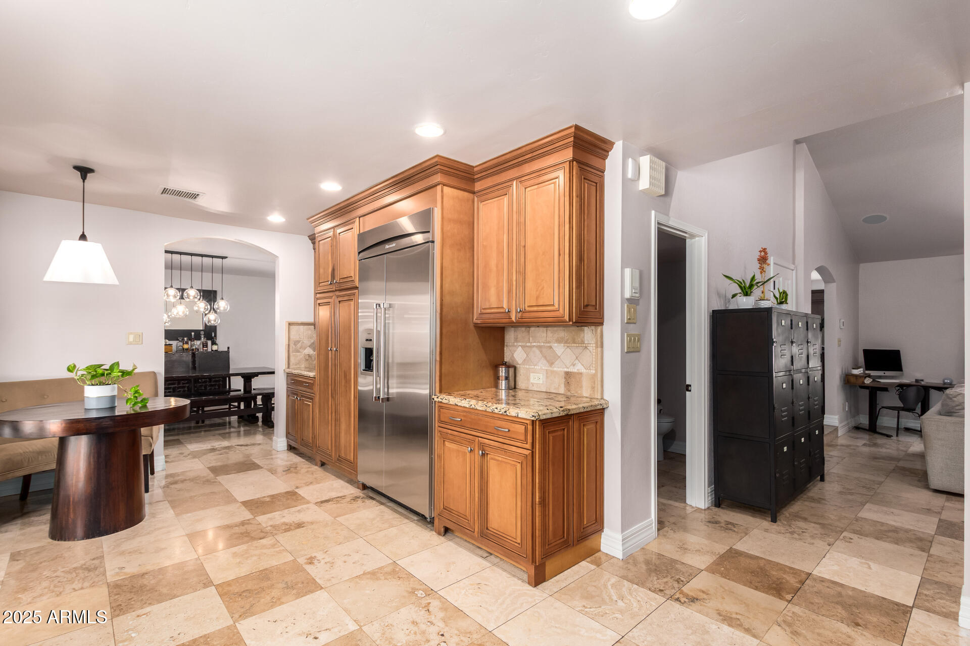 5803 North 45th Street Phoenix, AZ 85018 - Photo 28 of 72 a kitchen with stainless steel appliances kitchen island granite countertop a refrigerator and a sink