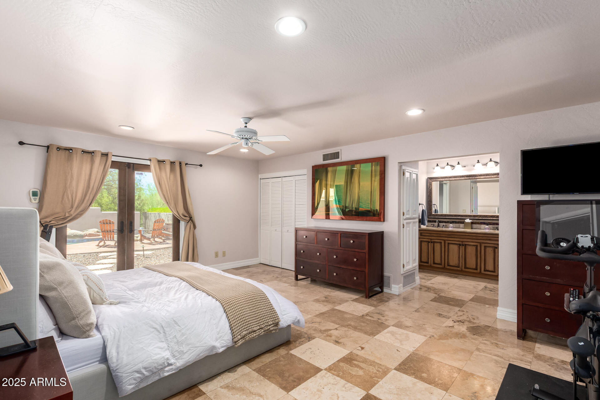 5803 North 45th Street Phoenix, AZ 85018 - Photo 30 of 72 a bedroom with a large bed and a flat screen tv