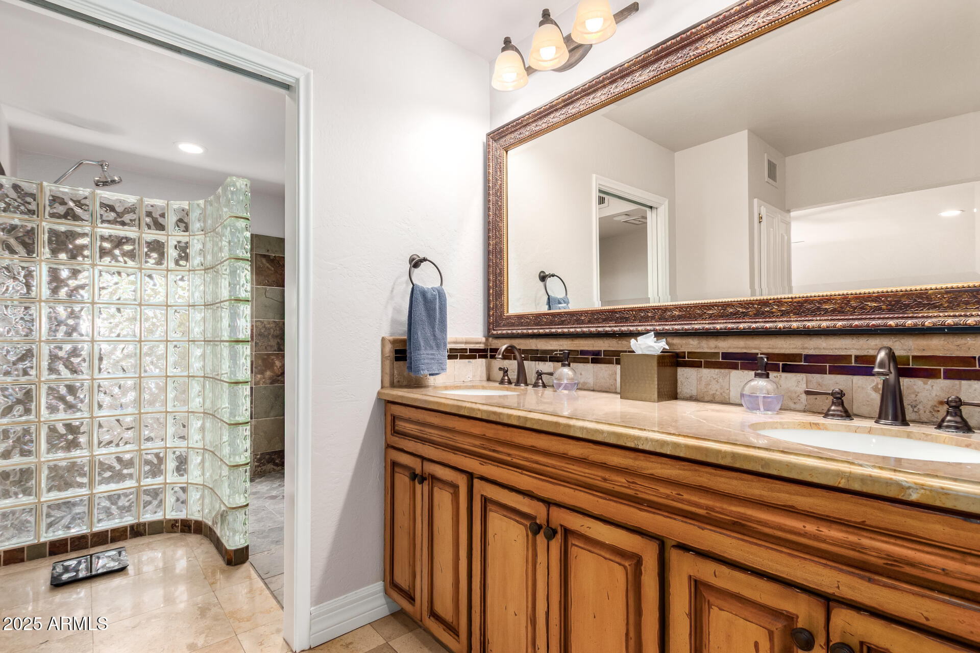 5803 North 45th Street Phoenix, AZ 85018 - Photo 31 of 72 a bathroom with a sink a mirror and a shower