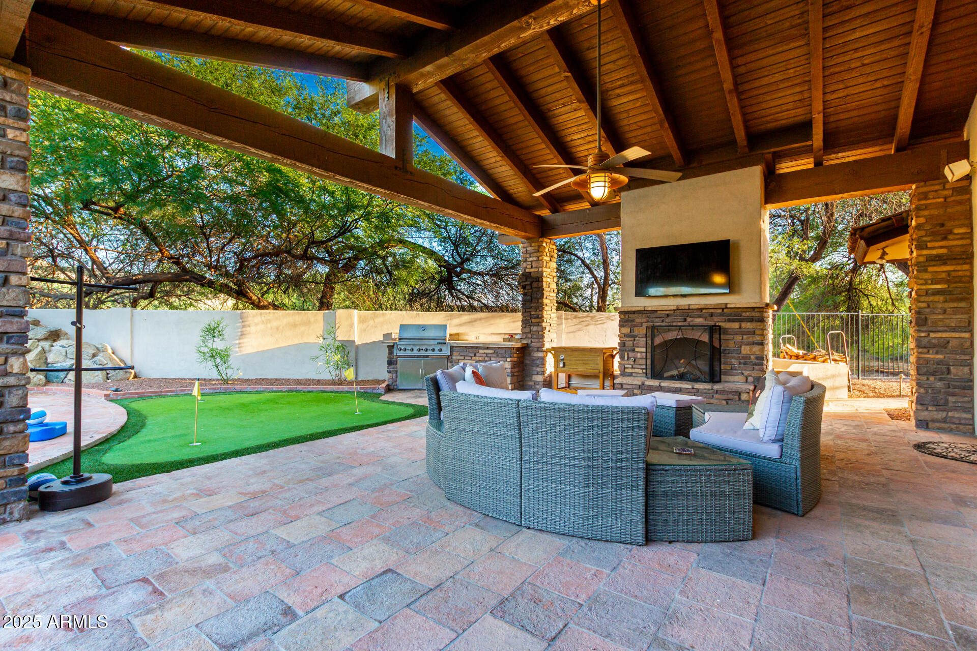 5803 North 45th Street Phoenix, AZ 85018 - Photo 39 of 72 a view of a patio with couches chairs potted plants and a palm tree