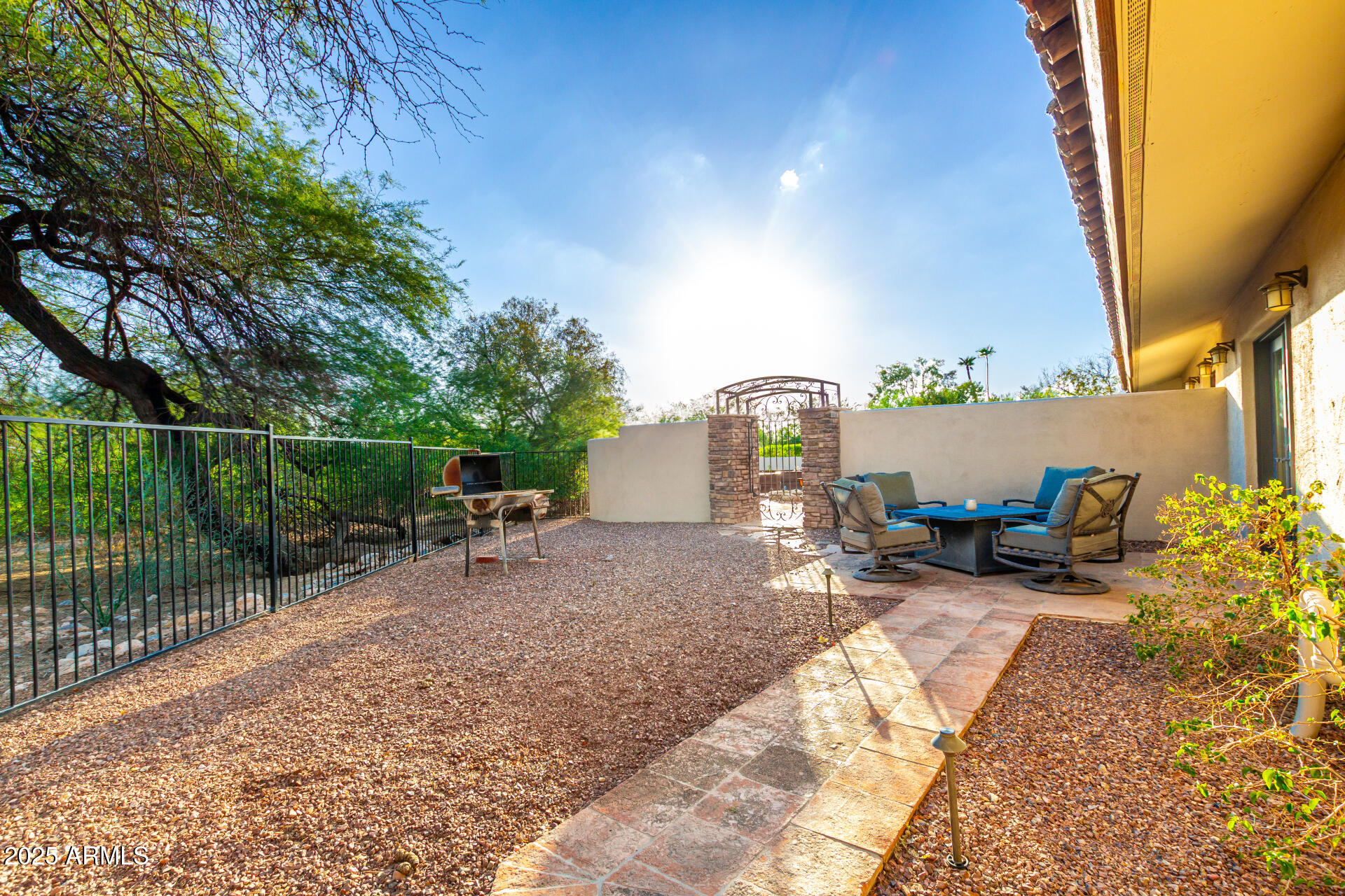 5803 North 45th Street Phoenix, AZ 85018 - Photo 59 of 72 a view of backyard with a table and chairs and potted plants