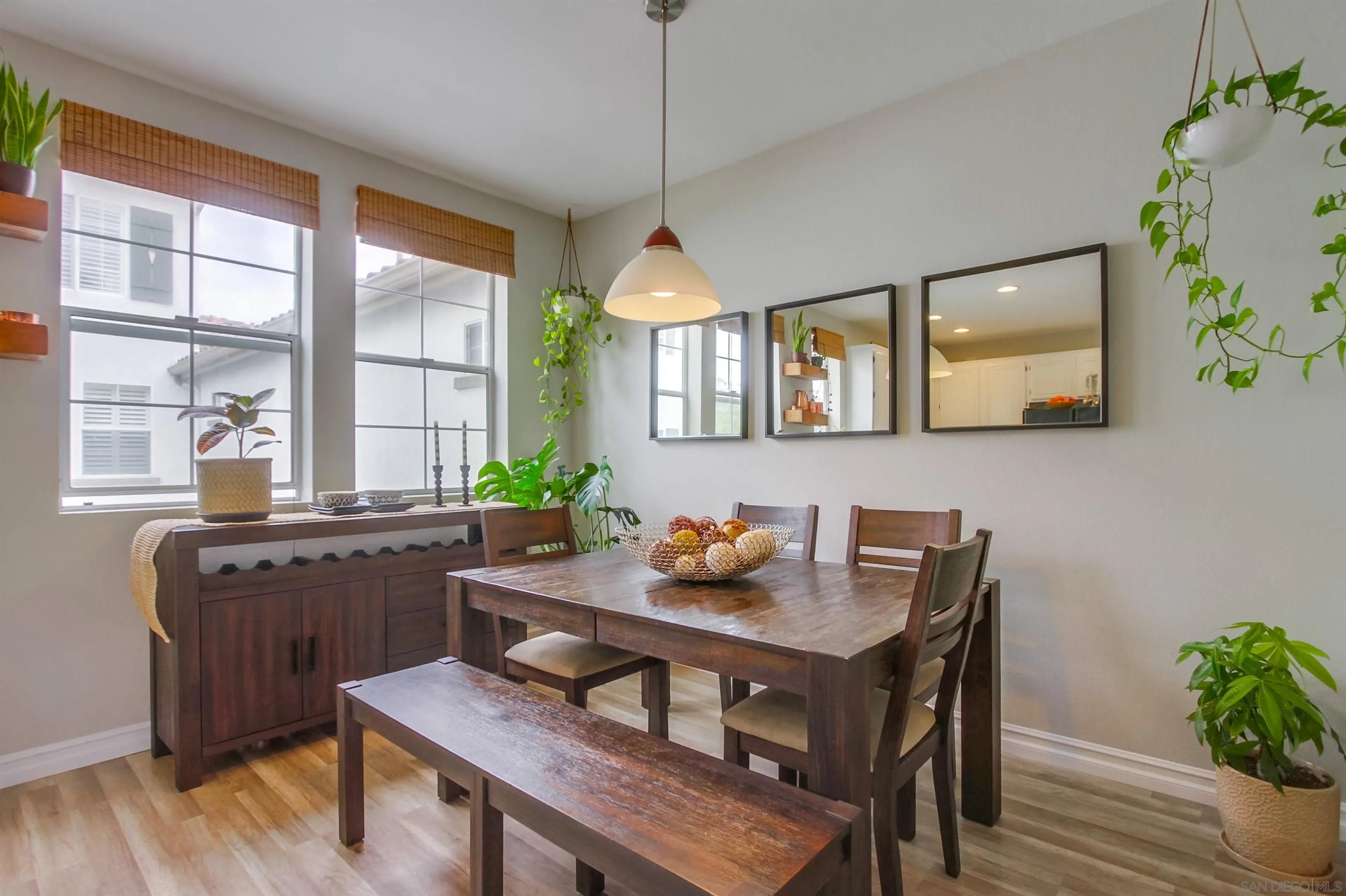 3147 Via Puerta Carlsbad, CA 92009 - Photo 14 of 32 a dining room with furniture a window and wooden floor