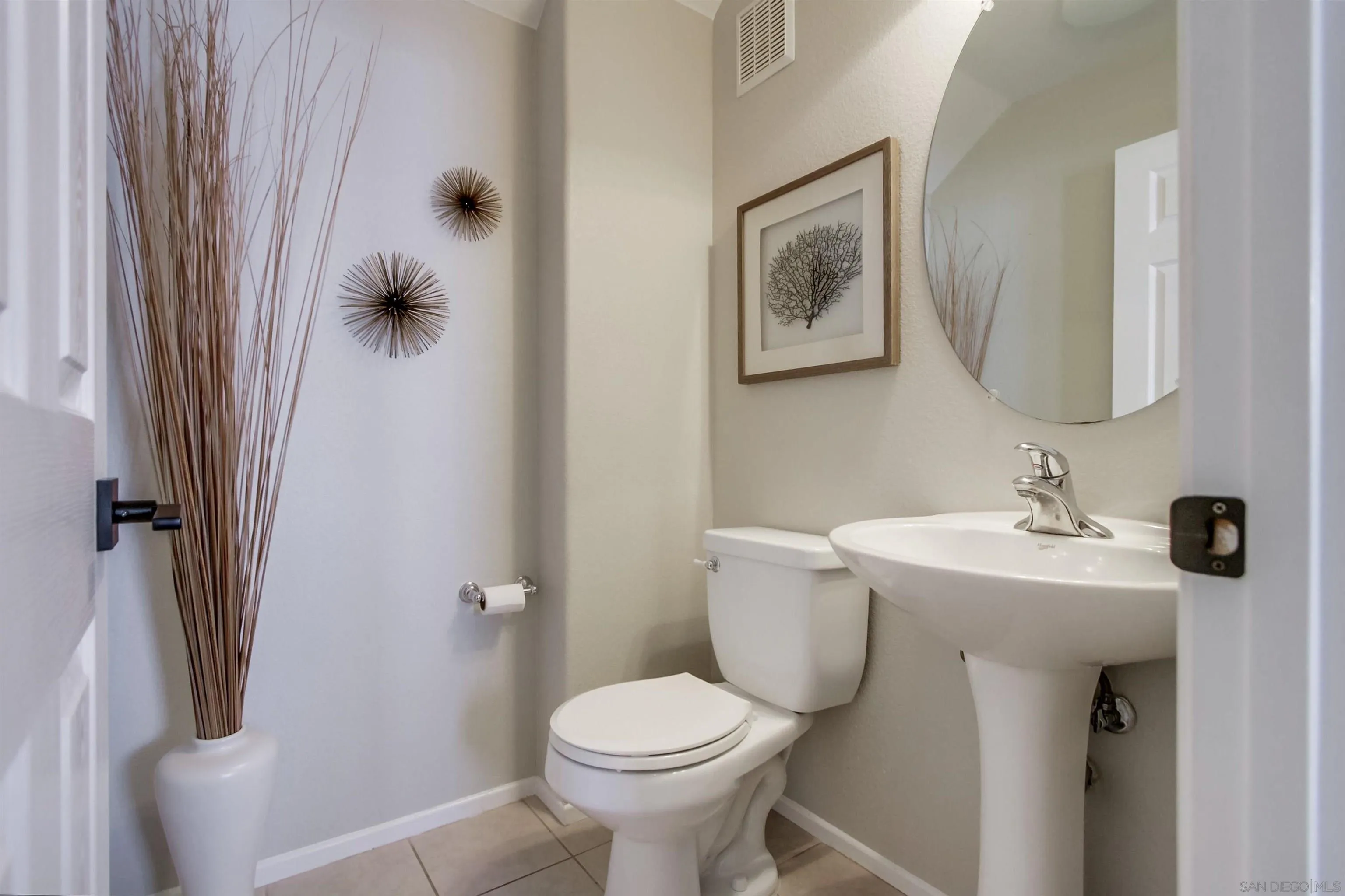 3147 Via Puerta Carlsbad, CA 92009 - Photo 15 of 32 a bathroom with a toilet sink and mirror