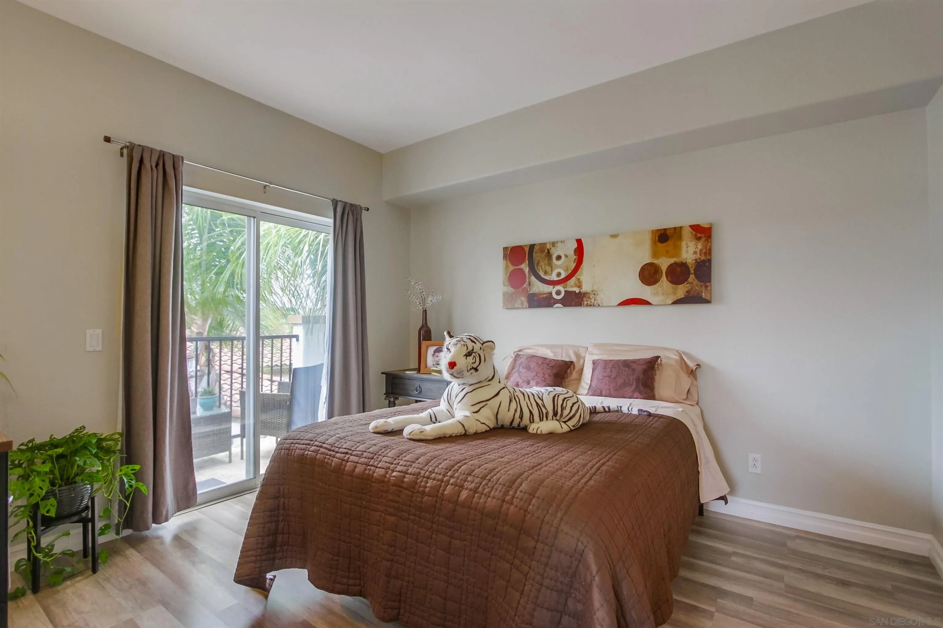 3147 Via Puerta Carlsbad, CA 92009 - Photo 18 of 32 a bedroom with a bed and a potted plant