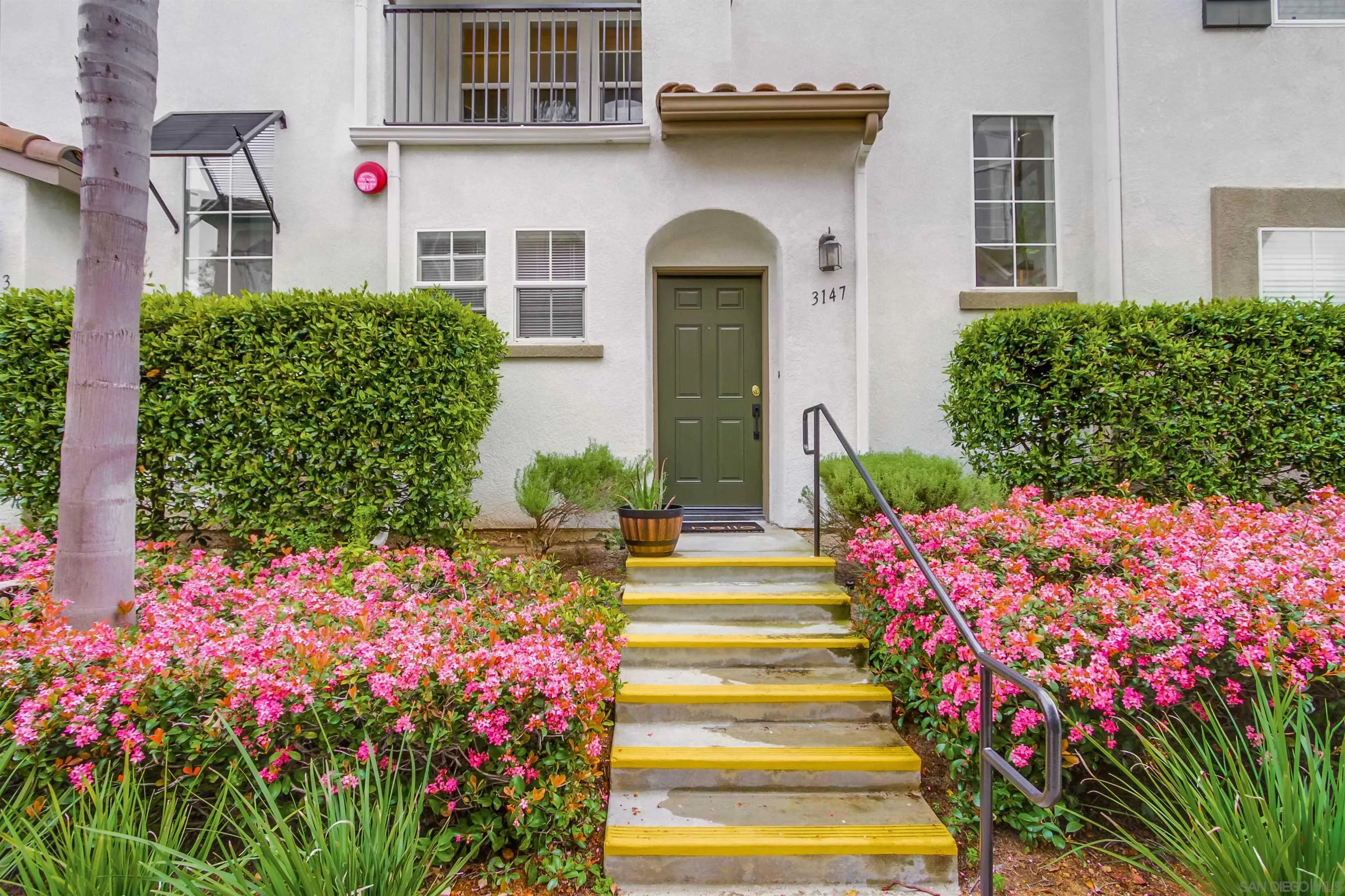 3147 Via Puerta Carlsbad, CA 92009 - Photo 3 of 32 a front view of a house with a yard