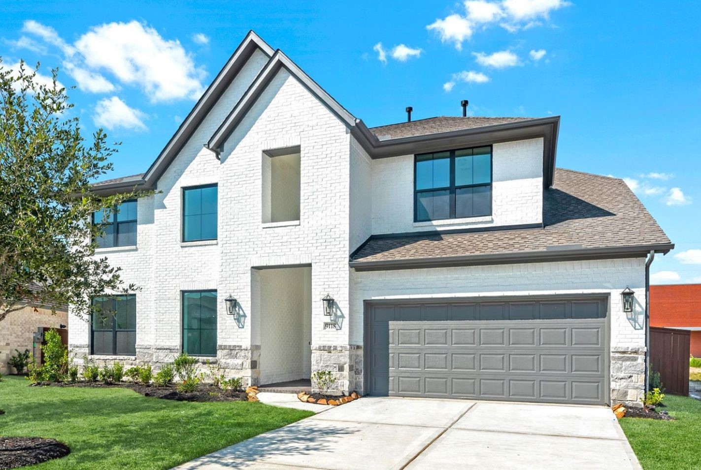 9118 Colonnade Way Manvel, TX 77578 - Photo 1 of 31 a front view of a house with garden