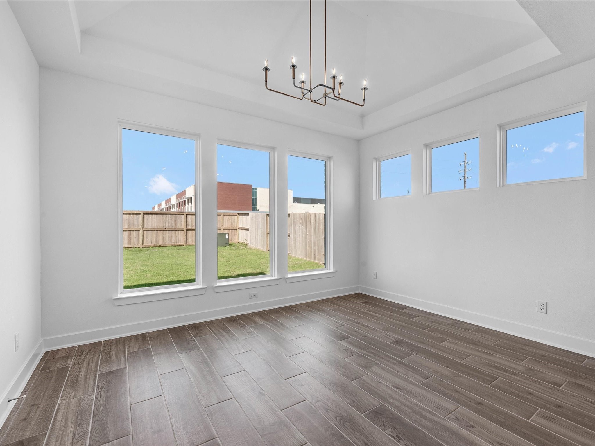 9118 Colonnade Way Manvel, TX 77578 - Photo 11 of 31 a view of an empty room with wooden floor and a window