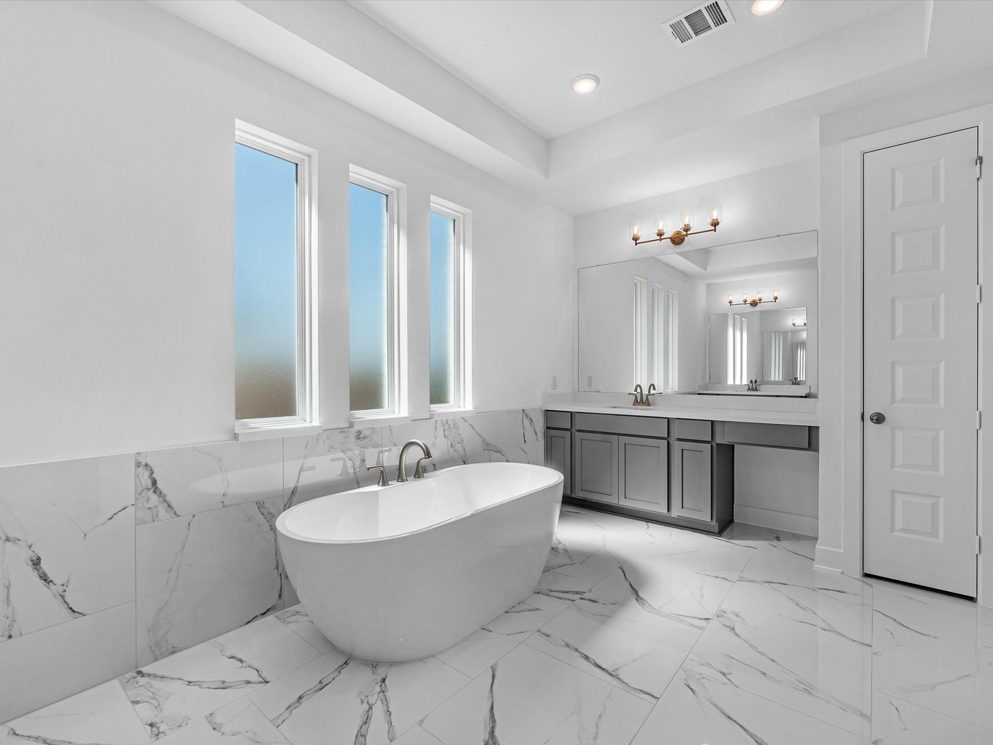 9118 Colonnade Way Manvel, TX 77578 - Photo 15 of 31 a spacious bathroom with a double vanity sink tub and a mirror