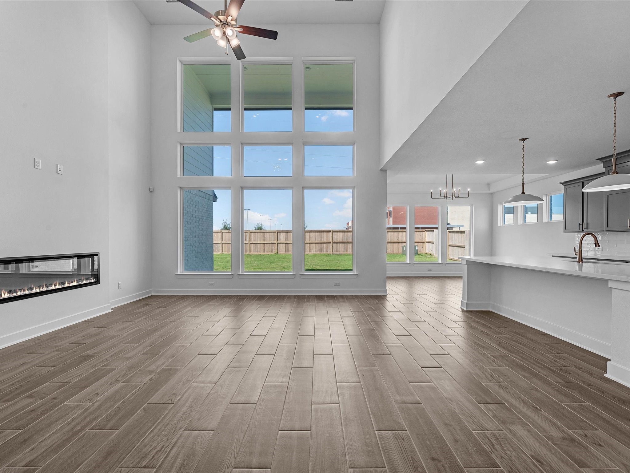9118 Colonnade Way Manvel, TX 77578 - Photo 4 of 31 wooden floor in an empty room with a kitchen