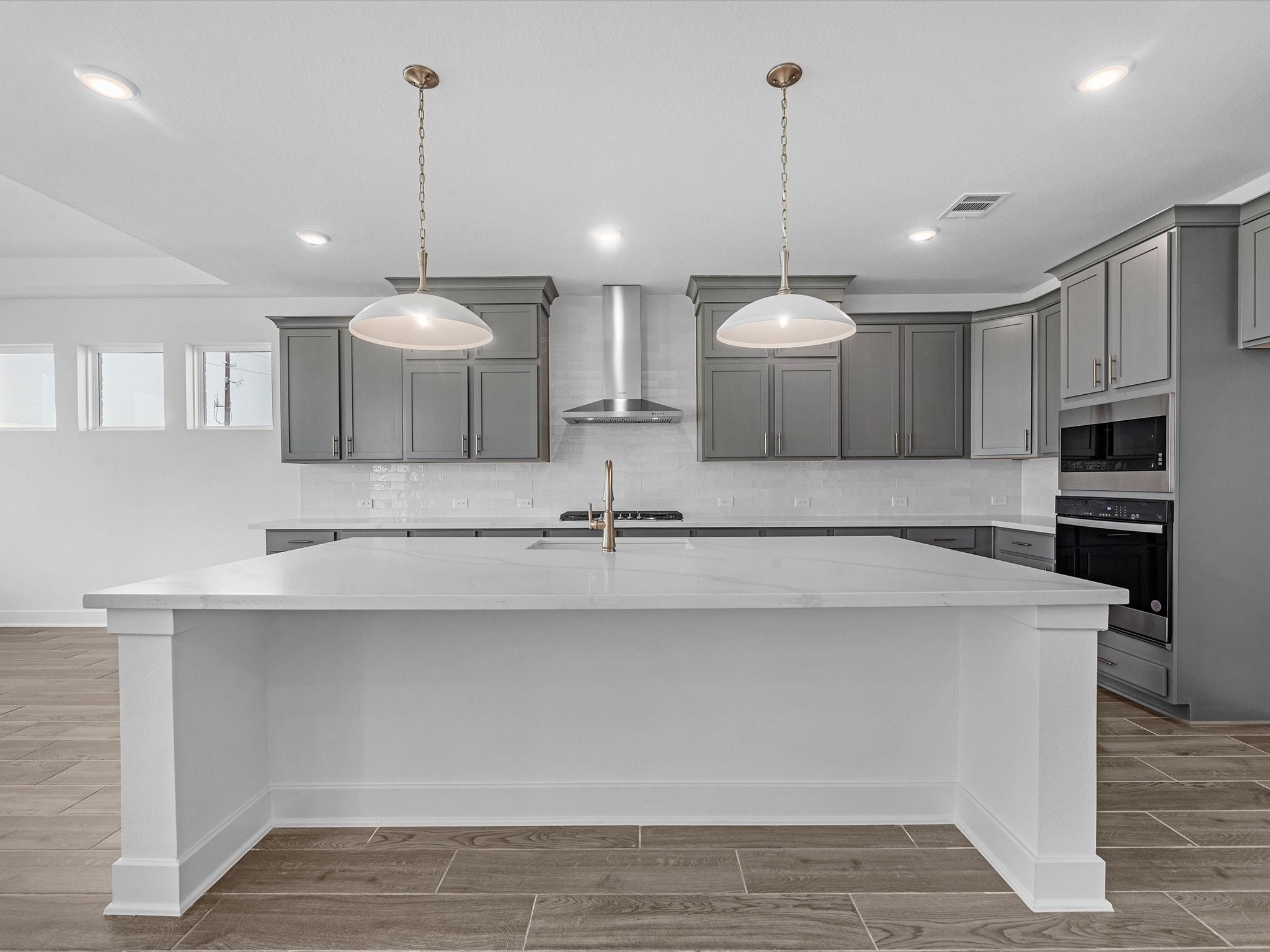 9118 Colonnade Way Manvel, TX 77578 - Photo 8 of 31 a view of a kitchen with kitchen island a sink stainless steel appliances and cabinets