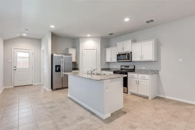 a bedroom with a bed and painting on the wall