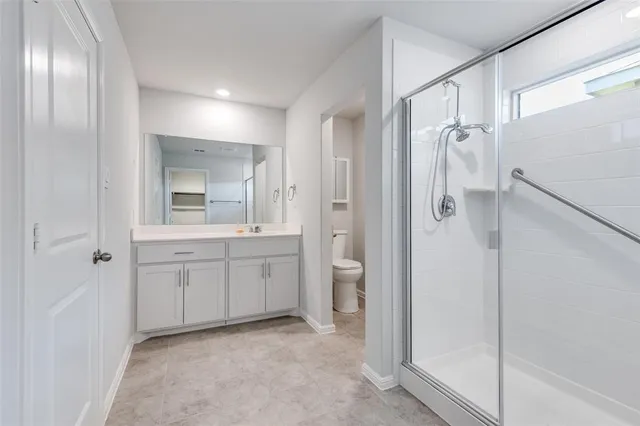 a bathroom with a glass shower door