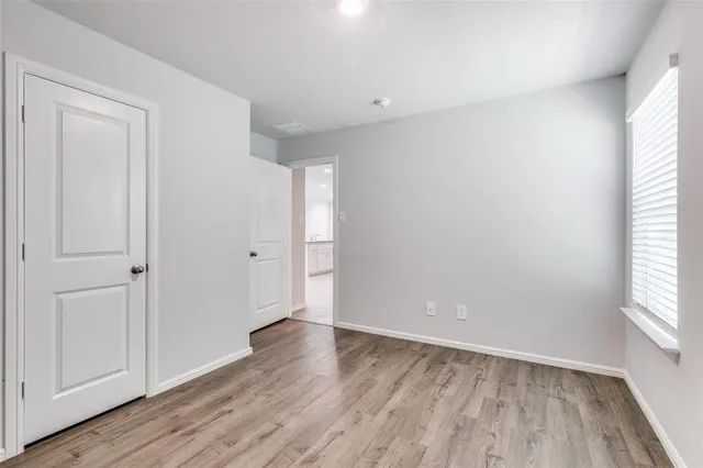 a view of an empty room and wooden floor