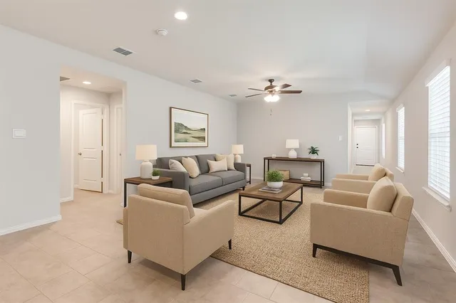 a living room with furniture and a chandelier