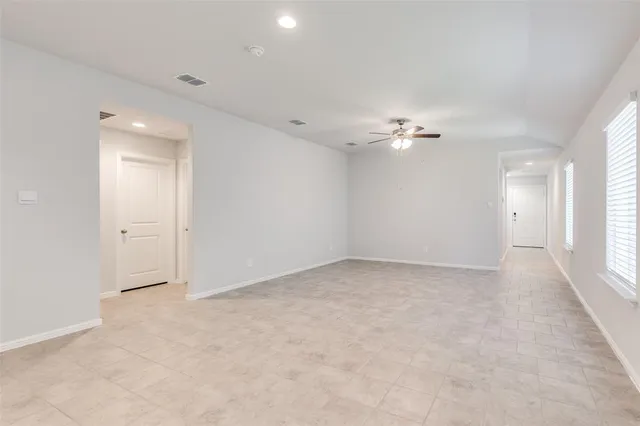 a view of a livingroom with a ceiling fan and window