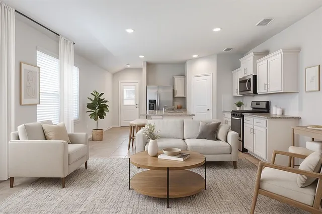 a open kitchen with white cabinets and stainless steel appliances