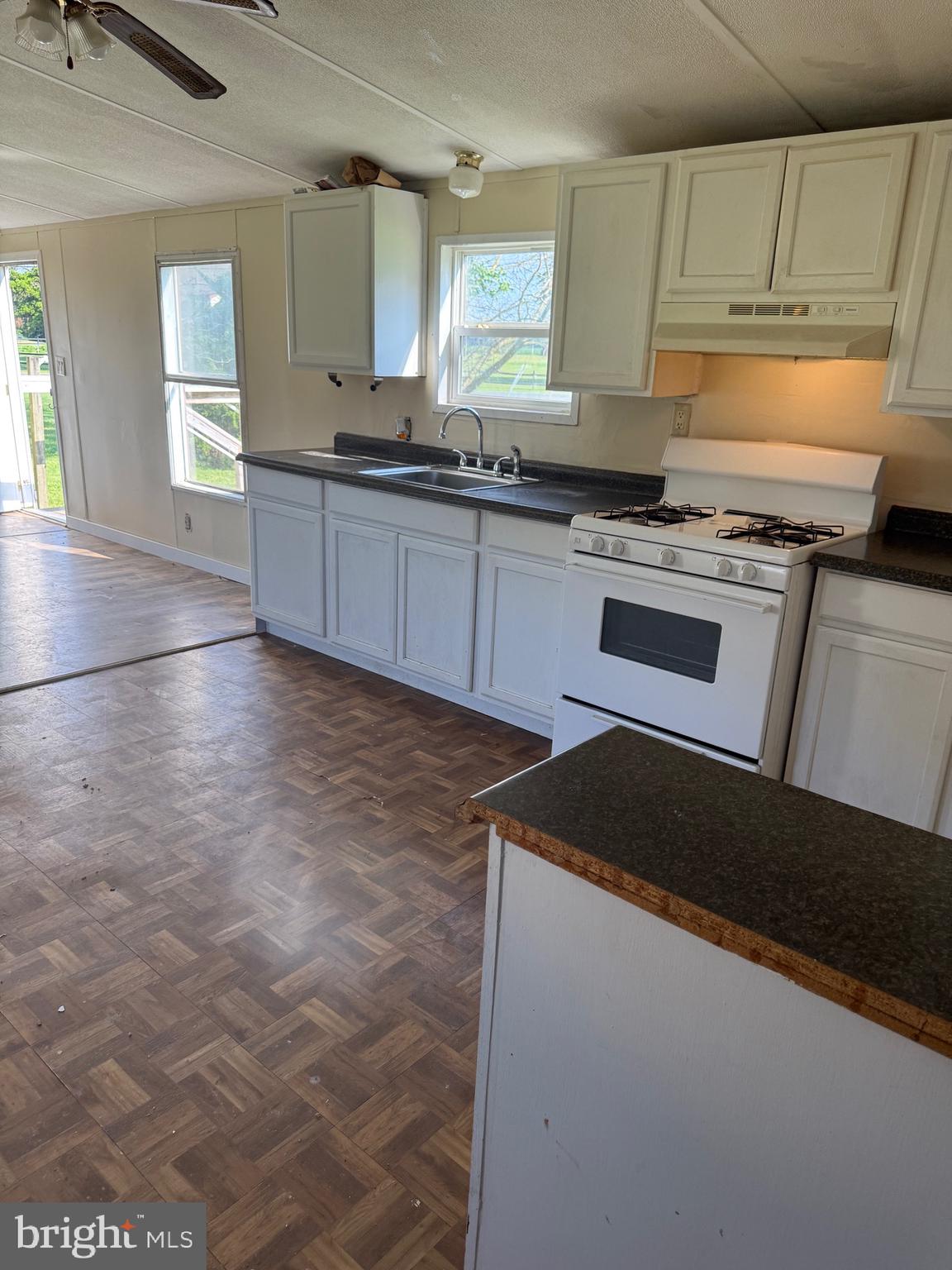 16 Abbotts Pond Road Greenwood, DE 19950 - Photo 18 of 19 a kitchen with granite countertop a sink stove and cabinets