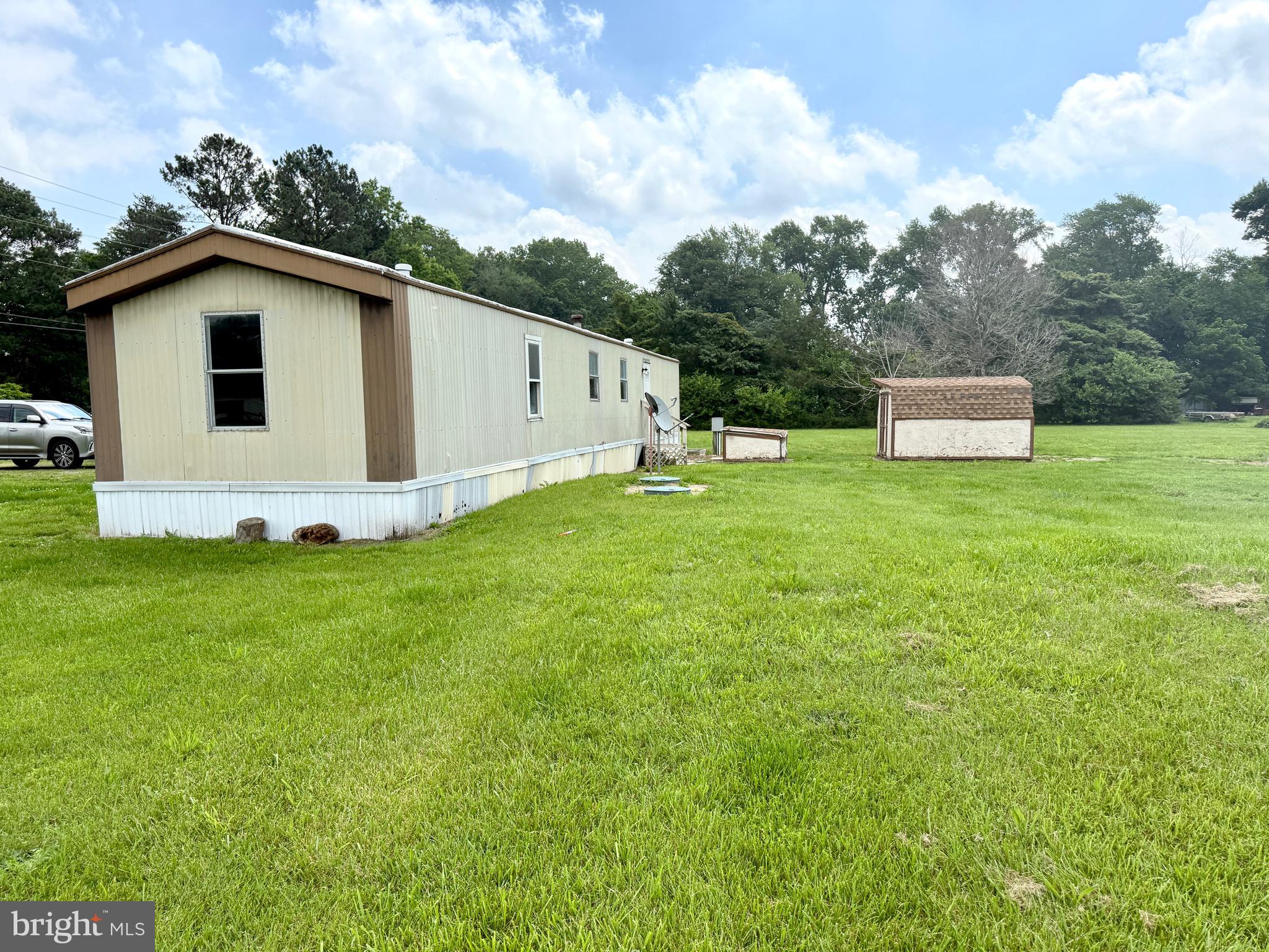 16 Abbotts Pond Road Greenwood, DE 19950 - Photo 3 of 19 a white house that has a big yard with wooden fence