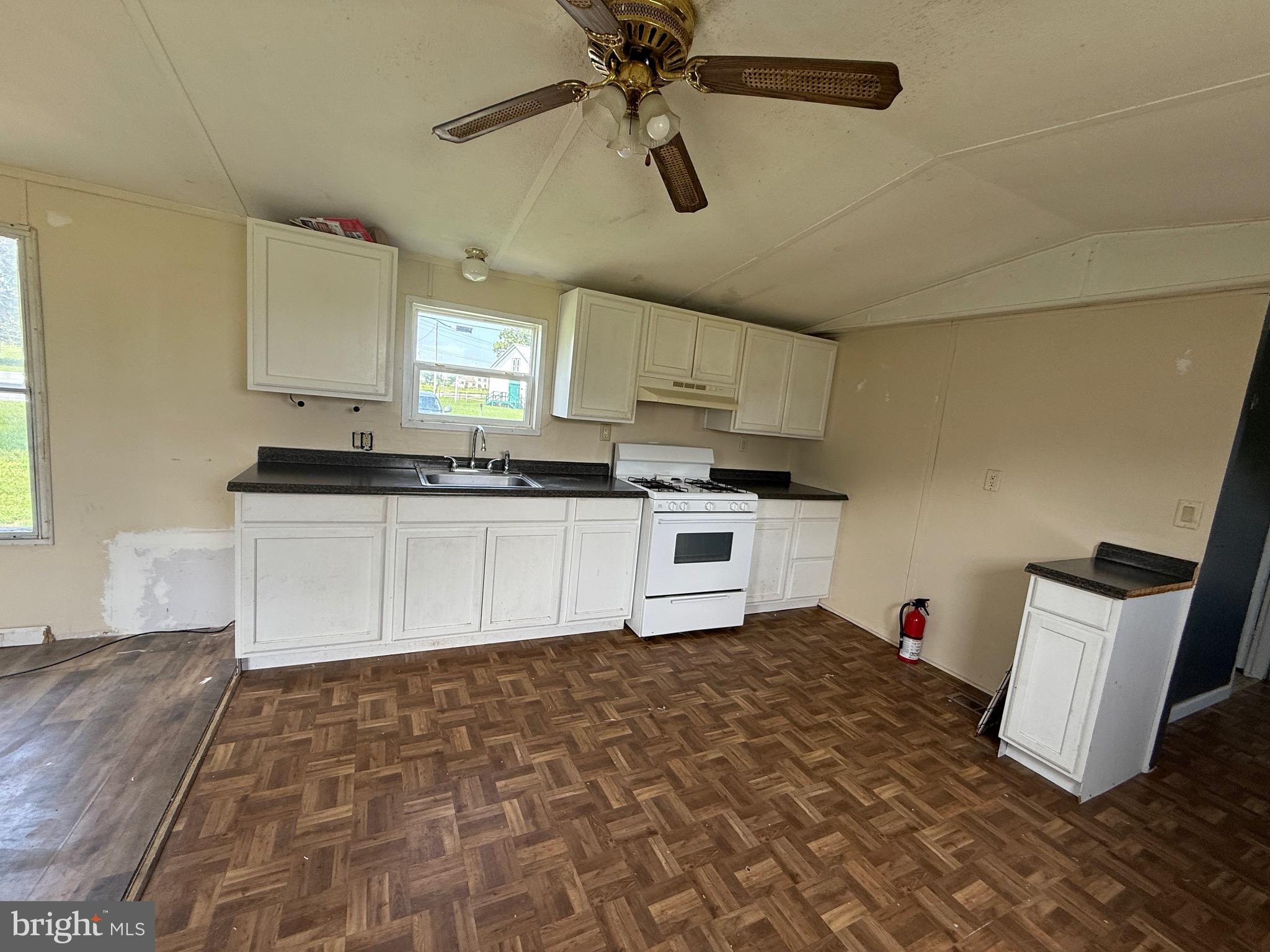16 Abbotts Pond Road Greenwood, DE 19950 - Photo 6 of 19 a kitchen with granite countertop a stove a sink and a refrigerator