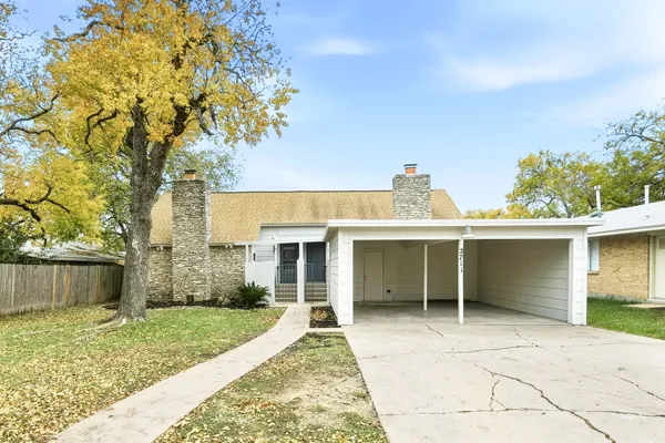 a view of a house with a yard and a garage