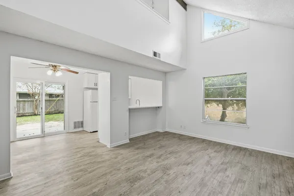 an empty room with windows and closet