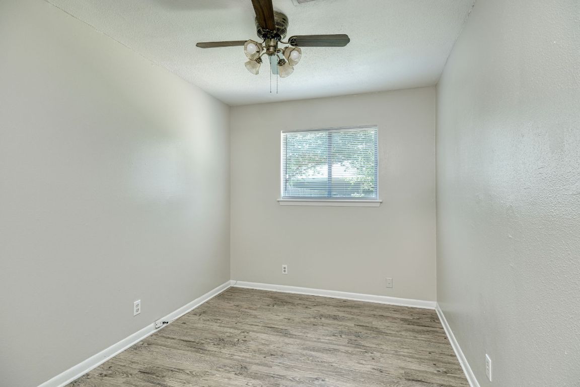 2711 St Edwards Circle, Unit 1 Austin, TX 78704 - Photo 7 of 14 Spare room with wood finished floors and a ceiling fan