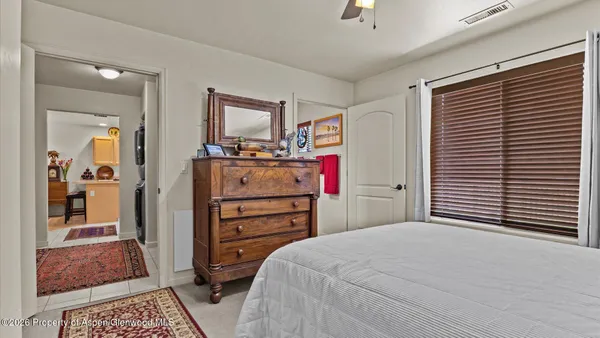 a bedroom with a bed and a dresser in it